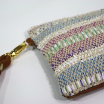 Hand-woven stripped purse with suede leathe