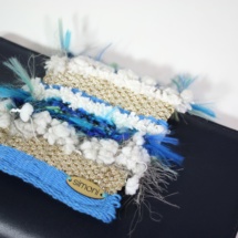 Blue leather clutch with woven fabric