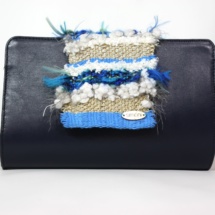 Blue leather clutch with woven fabric