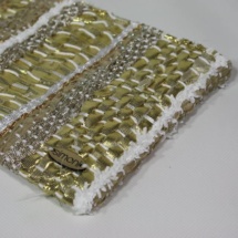 Gold and beige woven and plastic clutch detail