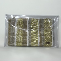 Gold and white plastic and woven clutch front
