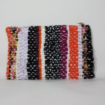 Orange and black woven and plastic clutch / woven back