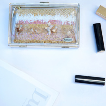 Gold and pink transparent and woven clutch