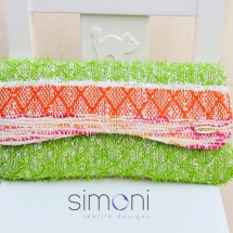 Orange green and white woven clutch