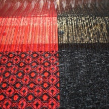 Weaving progress: final pieces in red and black