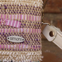 Woven, handmade purse with beige leather handle detail