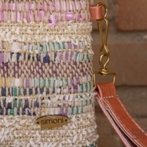 Woven purse with orange leather handle detail