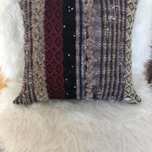 woven cushion with patterns and stripes